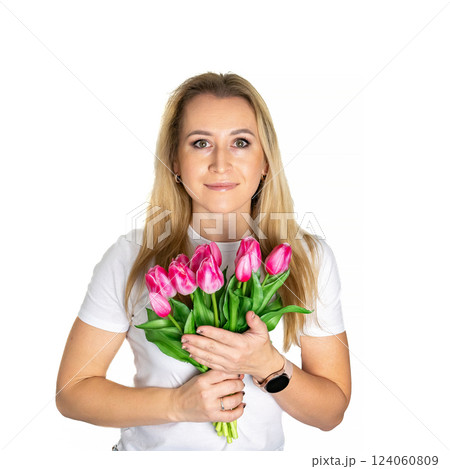 Beautiful blond mature european woman girl in white t-shirt is holding pink purple tulips isolated on white background Beautiful blond mature european woman girl in white t-shirt is holding pink purple tulips isolated on white background 124060809