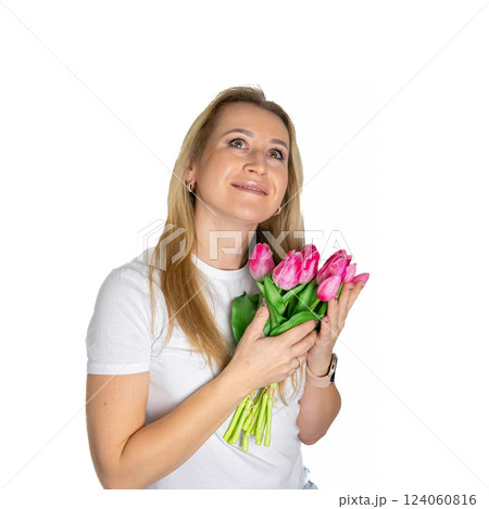 Beautiful blond mature european woman girl in white t-shirt is holding pink purple tulips isolated on white background 124060816