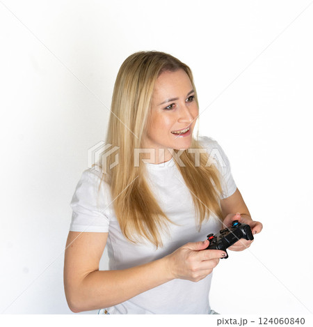 Photo of blond happy excited crazy smiling woman playing videogames addicted to playstation isolated on white background 124060840
