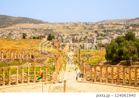 Ancient Roman forum central street with ruins and pillars and modern arab city in the background, Jerash, Jordan Ancient Roman forum central street with ruins and pillars and modern arab city in the background, Jerash, Jordan 124061940