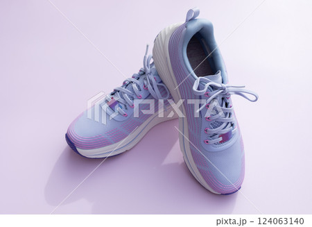 Purple Blue Female Sportive Running Shoes on Pink Background. Fashion, Training Footwear for Workout, Gym, Shoes For Woman. National Shoe The World Day. Horizontal  124063140