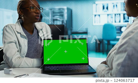 General practitioner consulting a black girl for treatment and diagnostic results, leveraging health data and expertise in a clinic environment. Medic helping with recovery. Camera B. General practitioner consulting a black girl for treatment and diagnostic results, leveraging health data and expertise in a clinic environment. Medic helping with recovery. Camera B. 124063717
