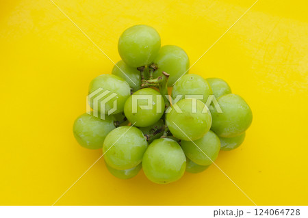 Shine muscat grape on yellow background. 124064728