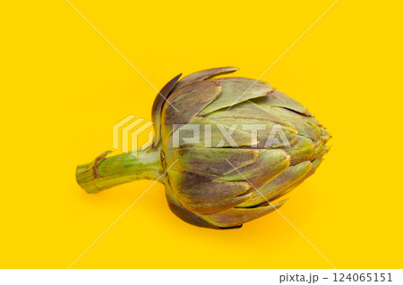 Fresh artichoke on yellow background. Fresh artichoke on yellow background. 124065151