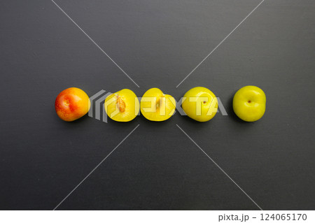 Fresh green plum fruit on dark background. Fresh green plum fruit on dark background. 124065170