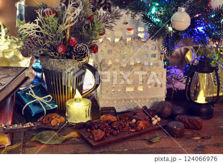 Still life with candle, lantern, crafted house made of paper and new year decorations. Merry Christmas and Happy Holidays greeting card. Winter background with xmas symbols.  124066976
