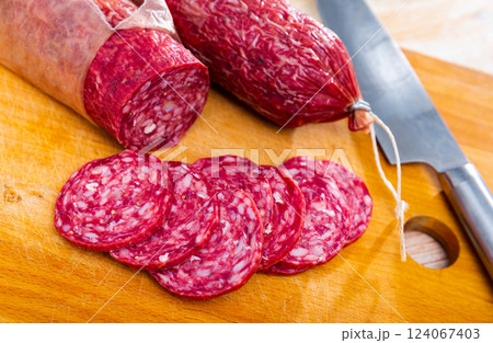 Slices of dry-cured sausage from Iberian pork seasoned with natural marinades Slices of dry-cured sausage from Iberian pork seasoned with natural marinades 124067403