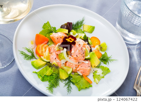 Tasty seafood ceviche from salmon with avocado, green dill and cumquat 124067422
