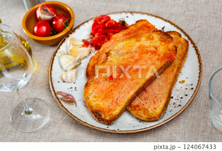 Sandwiches slices of bread smeared with olive oil and juice of fresh sweet and sour tomatoes 124067433