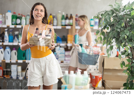 Young woman choosing beauty box in supermarket 124067473
