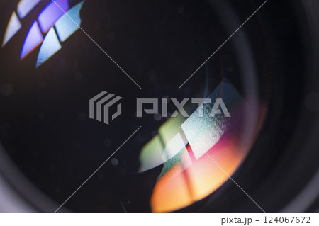Close-up of a camera lens with colorful reflections 124067672