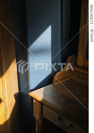 Sunlight casting a shadow on a blue wall Sunlight casting a shadow on a blue wall 124067686