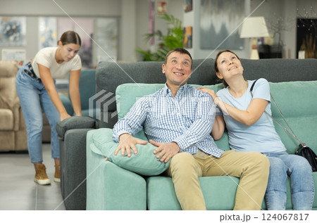 Married couple chooses the best new sofa in furniture store Married couple chooses the best new sofa in furniture store 124067817