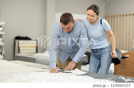 Married couple chooses the best new sofa in furniture store Married couple chooses the best new sofa in furniture store 124068107