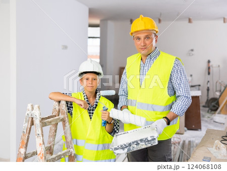 Boy with father holding renovating home tools Boy with father holding renovating home tools 124068108
