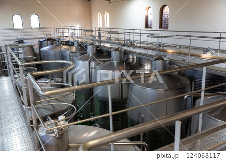 Interior of winery with stainless steel tanks Interior of winery with stainless steel tanks 124068117