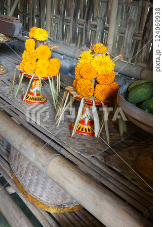 Traditional balinese offerings to gods in Bali with flowers and aromatic sticks Traditional balinese offerings to gods in Bali with flowers and aromatic sticks 124069938