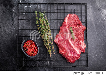 Raw hanging tender or onglet beef steak. black background. top view 124070031