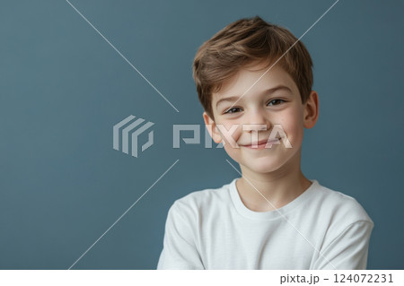 Portrait of happy smiling boy posing on solid background 124072231