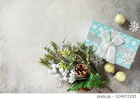 Xmas background. Christmas presents gift blue box and tree branch decor. Top view flat lay background. Copy space. Xmas background. Christmas presents gift blue box and tree branch decor. Top view flat lay background. Copy space. 124072285
