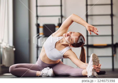 Yoga exercises and streching. Young beautiful woman in sportive clothes have fitness day in the gym 124075398