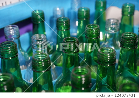 Empty bottles of the Korean liquor soju are piled up. 124075431