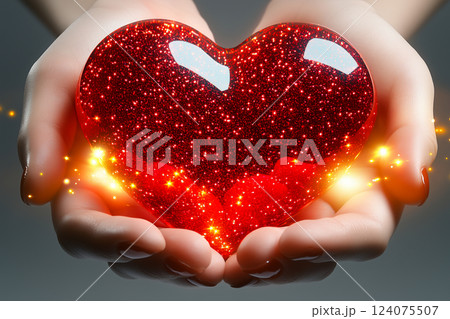Red Heart Sparkling in Hands on Light Background 124075507