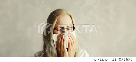 Sick exhausted woman sneezing blow nose using tissue, unhealthy suffering girl feels unwell 124076670
