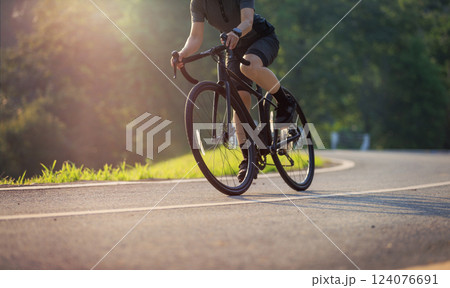 Woman cycling on summer park trail 124076691