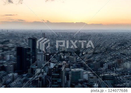 Fading sunlight casts a golden glow over Tokyo while a ghosting effect 124077686