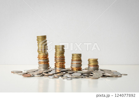 Coins stacked in a row, from high to low. 124077892