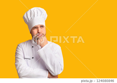 Pensive Chef Man Thinking About New Recipe Touching Chin Standing Over Yellow Studio Background. Panorama 124080846