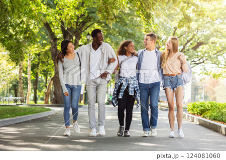 Multiethnic group of students walking in park after university, happily chatting and having fun, copy space Multiethnic group of students walking in park after university, happily chatting and having fun, copy space 124081060