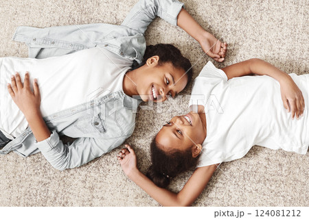 Two lovely african sisters laying on carpet face to face at home, panorama Two lovely african sisters laying on carpet face to face at home, panorama 124081212