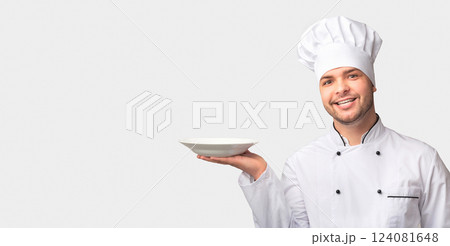 Chef Man Holding Empty Plate Smiling At Camera Standing Over White Background. Studio Shot 124081648