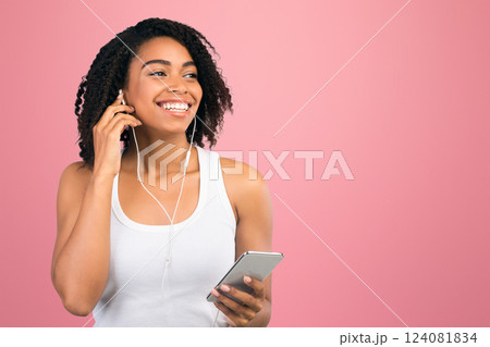 Enjoy The Music. Happy african american woman listening to music on mobile phone with headphones. Free space, panorama Enjoy The Music. Happy african american woman listening to music on mobile phone with headphones. Free space, panorama 124081834