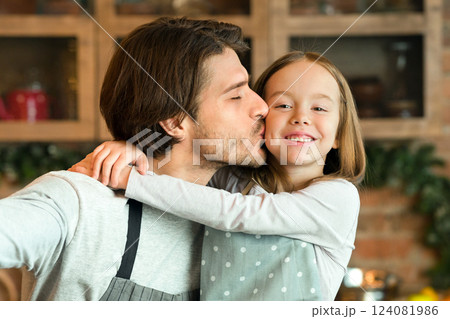 Father's Love. Loving Dad Taking Selfie With His Little Daughter While Cooking Together In Kitchen, Having Fun At Home, Wearing Aprons, Cute Girl Cuddling Daddy And Smiling To Camera, Closeup Father's Love. Loving Dad Taking Selfie With His Little Daughter While Cooking Together In Kitchen, Having Fun At Home, Wearing Aprons, Cute Girl Cuddling Daddy And Smiling To Camera, Closeup 124081986