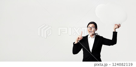 Business Idea. Excited Businesswoman Holding Empty Speech Bubble Pointing Finger Up Over White Studio Background. Mockup Business Idea. Excited Businesswoman Holding Empty Speech Bubble Pointing Finger Up Over White Studio Background. Mockup 124082119