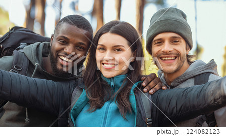 Close up portrait of cheerful international friends two guys and girl taking selfie at forest 124082123