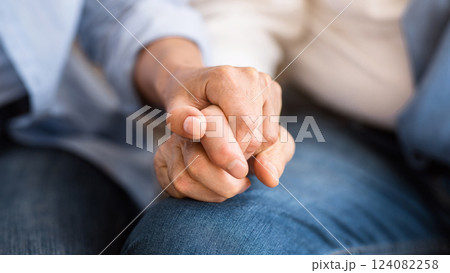 Love and support concept. Senior couple tenderly holding hands, closeup Love and support concept. Senior couple tenderly holding hands, closeup 124082258