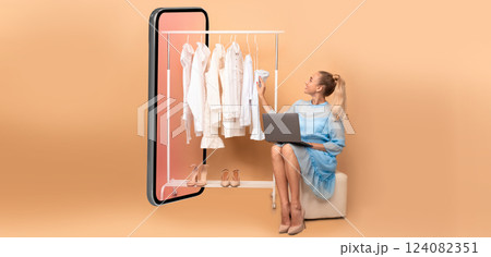 Woman Shopping Online Using Laptop Sitting Near Big Smartphone Choosing Clothes On Rail Over Beige Studio Background. Ecommerce, Fashion And Technology. Collage, Panorama Woman Shopping Online Using Laptop Sitting Near Big Smartphone Choosing Clothes On Rail Over Beige Studio Background. Ecommerce, Fashion And Technology. Collage, Panorama 124082351