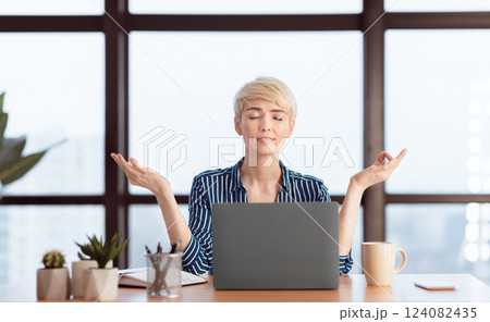 Mature Businesswoman Meditating Relaxing At Workplace Sitting In Modern Office. Meditation And Work Stress Relief. Selective Focus Mature Businesswoman Meditating Relaxing At Workplace Sitting In Modern Office. Meditation And Work Stress Relief. Selective Focus 124082435