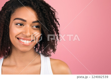 Beauty Portrait. Happy black woman looking at copy space over white studio background, panorama Beauty Portrait. Happy black woman looking at copy space over white studio background, panorama 124082539