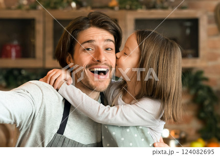 I Love You, Daddy. Little Girl Cuddling And Kissing Father While They Taking Selfie In Kitchen, Having Fun At Home Together, Closeup I Love You, Daddy. Little Girl Cuddling And Kissing Father While They Taking Selfie In Kitchen, Having Fun At Home Together, Closeup 124082695
