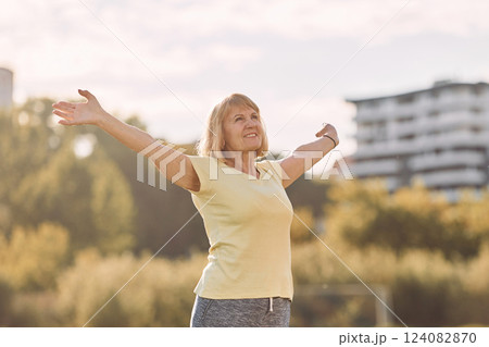 Standing and enjoying the life. Senior woman having nice weekend outdoors on the field at sunny day Standing and enjoying the life. Senior woman having nice weekend outdoors on the field at sunny day 124082870
