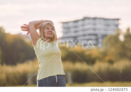 Standing and enjoying the life. Senior woman having nice weekend outdoors on the field at sunny day Standing and enjoying the life. Senior woman having nice weekend outdoors on the field at sunny day 124082873