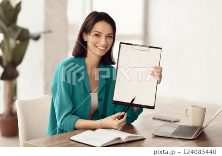 Doing Survey Research. Young woman showing clipboard paperholder working at office, copyspace Doing Survey Research. Young woman showing clipboard paperholder working at office, copyspace 124083440