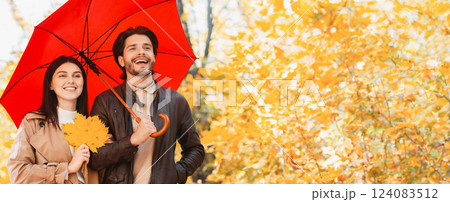 Happy couple walking under umbrella at rainy autumn day, free space 124083512