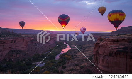 Vibrant hot air balloons ascend over a canyon at dawn, creating a mesmerizing golden spectacle. 124083633