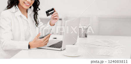Online Shopping. Satisfied woman using smartphone and credit card to buy stuff on the Internet 124083811